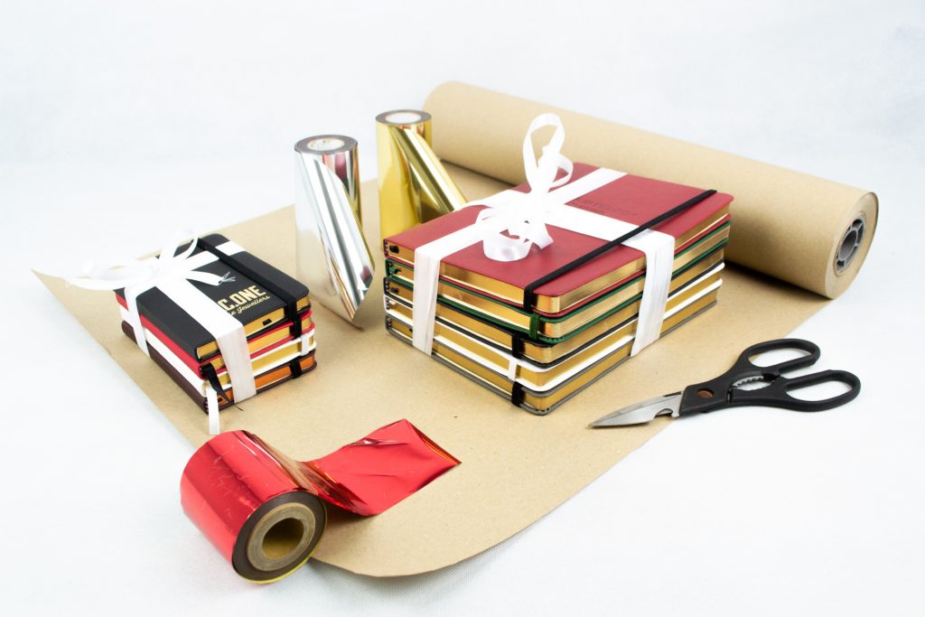 Notebooks being wrapped in paper and ribbon